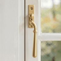 The Right Handed 16mm Modern Satin Brass Espagnolette Window Handle Mounted on a Classic White Coloured Window Frame in a Country Home - Digital Illustration The Right Handed 16mm Modern Satin Brass Espagnolette Window Handle Mounted on a Classic White Coloured Window Frame in a Country Home - Digital Illustration