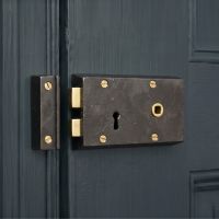 The Right Handed "Hartwin" Small Iron Rim Lock Mounted on a Wooden Blue Home Entrance - Digital Illustration The Right Handed "Hartwin" Small Iron Rim Lock Mounted on a Wooden Blue Home Entrance - Digital Illustration