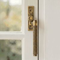 The Right Handed Aged Brass Espag Window Handle Fitted on a Handpainted Window Frame in a Modern Home - Digital Illustration The Right Handed Aged Brass Espag Window Handle Fitted on a Handpainted Window Frame in a Modern Home - Digital Illustration