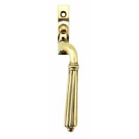 The Right Handed Aged Brass Reeded Georgian Espagnolette Window Handle on a White Background The Right Handed Aged Brass Reeded Georgian Espagnolette Window Handle on a White Background