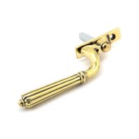 The Right Handed Aged Brass Reeded Georgian Espagnolette Window Handle on a White Background Shown on its Side The Right Handed Aged Brass Reeded Georgian Espagnolette Window Handle on a White Background Shown on its Side