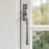 The Right Handed Bright Chrome Hammered Espag Window Handle Mounted on a Classic White Wooden Window Frame - Digital Illustration The Right Handed Bright Chrome Hammered Espag Window Handle Mounted on a Classic White Wooden Window Frame - Digital Illustration