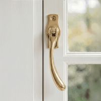 The Right Handed Polished Brass Peardrop Window Handle Screwed onto a Classic White Window Frame in a Contemporary Home - Digital Illustration The Right Handed Polished Brass Peardrop Window Handle Screwed onto a Classic White Window Frame in a Contemporary Home - Digital Illustration