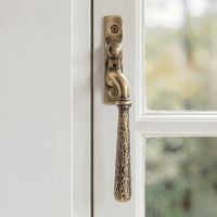 The Right Handed Polished Bronze Hammered Espag Window Handle on a Hand painted White Window Frame - Digital Illustration The Right Handed Polished Bronze Hammered Espag Window Handle on a Hand painted White Window Frame - Digital Illustration