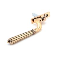 The Right Handed Polished Bronze Reeded Georgian Espagnolette Window Handle on a White Background Shown on its Side 
