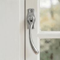 The Right Handed Polished Chrome Peardrop Window Handle Fitted on a White Window Frame in a Country Home - Digital Illustration 