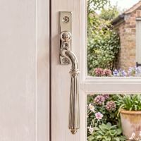 The Right Handed Polished Nickel Reeded Georgian Espagnolette Window Handle on a White Wooden Window Frame in a Country Home- Digital Illustration The Right Handed Polished Nickel Reeded Georgian Espagnolette Window Handle on a White Wooden Window Frame in a Country Home- Digital Illustration