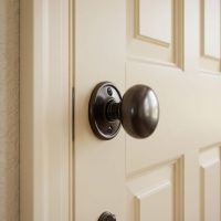 The Round Bronze Door Knob Set on a Cream Coloured Door in a Sunny Home Corridor - Digital Illustration The Round Bronze Door Knob Set on a Cream Coloured Door in a Sunny Home Corridor - Digital Illustration