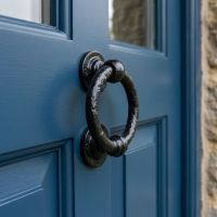 The Rustic Blacksmith Style Ring Door Knocker on a Blue Front Door Entrance - Digital Illustration The Rustic Blacksmith Style Ring Door Knocker on a Blue Front Door Entrance - Digital Illustration