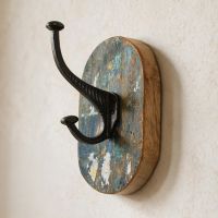 The Rustic Wood And Iron Coat Hook Shown Close Up Mounted on a Cream Coloured Interior Wall - Digital Illustration