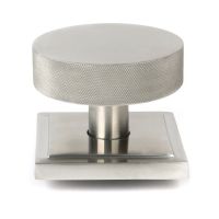 The Satin Stainless Steel Knurled Centre Door Knob on a Square Rose Shown Upright on a White Background The Satin Stainless Steel Knurled Centre Door Knob on a Square Rose Shown Upright on a White Background