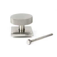 The Satin Stainless Steel Knurled Centre Door Knob on a Square Rose with Bolt Fitting on a White Background The Satin Stainless Steel Knurled Centre Door Knob on a Square Rose with Bolt Fitting on a White Background