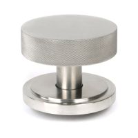The Satin Stainless Steel Knurled Centre Door Knob on an Art Deco Rose Shown Upright on a White Background 