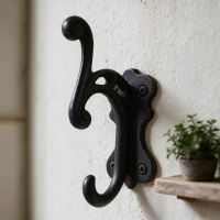 The Scrolled Antique Iron Coat Hook  Fitted on a Sunny Interior Wall - Digital Illustration 