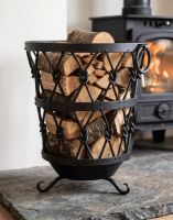 The Sherwood Iron Log Basket with Wood stacked inside next to a lit log Burner Stove - Digital Illustration The Sherwood Iron Log Basket with Wood stacked inside next to a lit log Burner Stove - Digital Illustration
