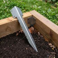 The Single Galvanised Railway Sleeper Corner Spike Laying on a Raised Flower Bed - Digital Illustration The Single Galvanised Railway Sleeper Corner Spike Laying on a Raised Flower Bed - Digital Illustration