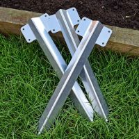 The Single Stainless Steel Railway Sleeper Straight Inline Spikes in Brown next to a Raised Flower Bed The Single Stainless Steel Railway Sleeper Straight Inline Spikes in Brown next to a Raised Flower Bed