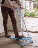 The Sky Blue Glenmore Sky Boot Jack Shown Being Used in a Rustic Cottage Porch Entrance - Digital Illustration 