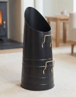 The Sleek Black & Polished Brass Coal Hod on a Cream Carpet in Front of a Glowing Log Burner Stove - Digital Illustration The Sleek Black & Polished Brass Coal Hod on a Cream Carpet in Front of a Glowing Log Burner Stove - Digital Illustration