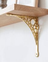 The Small 20cm x 22cm Polished Brass "Iron Bridge" Shelf Bracket Mounted on a Cream White Coloured Wall on a DIY Wooden Shelf - Digital Illustration 