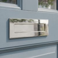 The Small Cast Brass Traditional Letter Plate in Polished Chrome on an Eggshell Blue Front Door - Digital Illustration 
