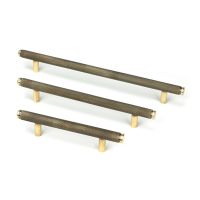 The Small Knurled Cabinet Pull Handle in Aged Brass Alongside Different Sizes on a White Background The Small Knurled Cabinet Pull Handle in Aged Brass Alongside Different Sizes on a White Background