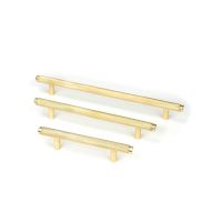 The Small Knurled Cabinet Pull Handle in Aged Brass Alongside Different Sizes on a White Background