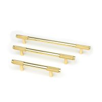 The Small Knurled Cabinet Pull Handle in Aged Brass Alongside Different Sizes on a White Background