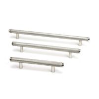 The Small Knurled Cabinet Pull Handle in Polished Stainless Steel Shown Alongside Other Sizes on a White Background The Small Knurled Cabinet Pull Handle in Polished Stainless Steel Shown Alongside Other Sizes on a White Background