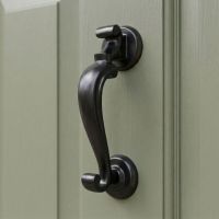 The Smooth Black Steel Doctor"s Style Door Knocker on an Olive Green Front Door - Digital Illustration