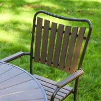 The Solis Round 4-Seater Outdoor Dining Set in Coffee Showing the Curved Slatted Backrest