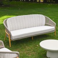 The Soria Woven 4-Piece Outdoor Lounge Set Showing the Benck on a Shaded Garden Lawn