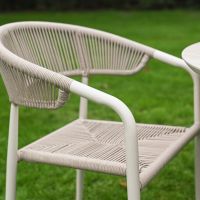 The Soria Woven 4-Seater Dining Set With a Side view of the Rope Weave Chair