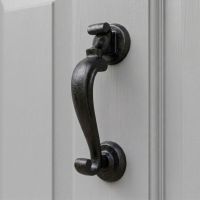 The Steel Beeswax Doctor"s Style Door Knocker on a Light Grey Coloured Front Door to a Country Home - Digital Illustration