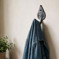 The Steel Leaf Shaped Hook Displayed with a Denim Jacket Hung on It - Digital Illustration 