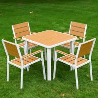 The Strata Slatted 4-Seater Outdoor Dining Set Shown on a lush Green Garden Lawn-compressed