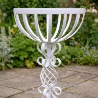 The "Stretton" Victorian Wrought Iron Basket Planter Stand in a White Finish Showing a Close up of the Detailed and Decorative Spiral Scrollwork on the Base - Digital Illustration 