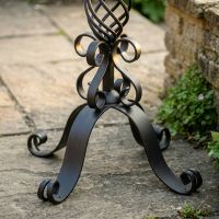 The "Stretton" Victorian Wrought Iron Basket Planter Stand in a Black Finish Looking Close up at the Base of the Planter - Digital Illustration 