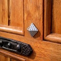 The Studded Solid Brass Door stud in a Chrome Finish Nailed into a Wooden Door - Digital Illustration The Studded Solid Brass Door stud in a Chrome Finish Nailed into a Wooden Door - Digital Illustration