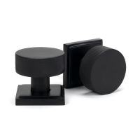 The Knurled Mortice/Rim Knob Set on a Square Rose in Matt Black Shown Upright on a White Background The Knurled Mortice/Rim Knob Set on a Square Rose in Matt Black Shown Upright on a White Background