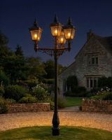 The Victorian Quadruple Lamp Post and Lantern Set Shown Lit up at Night in Front of a Grand Home - Digital Illustration 