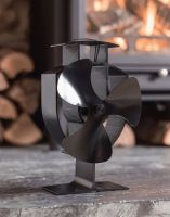 The Three Blade Heat Powered Stove Fan Displayed in a Modern Living Room with a Lit Log Burner Stove Behind - Digital Illustration The Three Blade Heat Powered Stove Fan Displayed in a Modern Living Room with a Lit Log Burner Stove Behind - Digital Illustration
