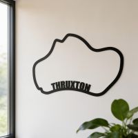 The Thruxton Race Track Black Steel Wall Art with Writing on Display Mounted on a Living Room Wall - Digital Illustration The Thruxton Race Track Black Steel Wall Art with Writing on Display Mounted on a Living Room Wall - Digital Illustration