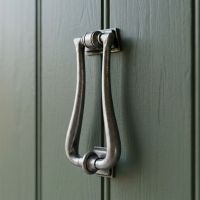The Traditional Antique Pewter "Art Deco" Door Knocker on a Sage Green Wooden Front Door - Digital Illustration