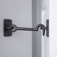 The Traditional Black Iron 3" Loose Ring Cabin Hook in a Modern Home on a White Door - Digital Illustration