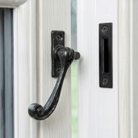 The Traditional Black Iron Window Casement Stay With Mortice Plate Mounted on a White Window Frame - Digital Illustration The Traditional Black Iron Window Casement Stay With Mortice Plate Mounted on a White Window Frame - Digital Illustration