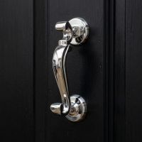 The Traditional Doctor"s Door Knocker Polished in Stainless Steel on a Dark Black Front Door to a Stately home - Digital Illustration