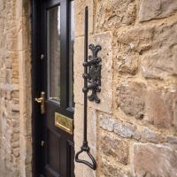 The Traditional Iron Antique Black Gothic Style Door Bell Pull on the Front of a Grand House Front Entrance - Digital Illustration