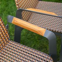 The Tribeca Weave 8-Piece Patio Dining Set Showing a Close up of the Wood Effect Chair Armrest