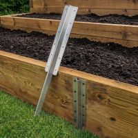 The Triple Stainless Steel Railway Sleeper Straight Inline Spikes in Brown next to a Raised Flower Bed - Digital Illustration 